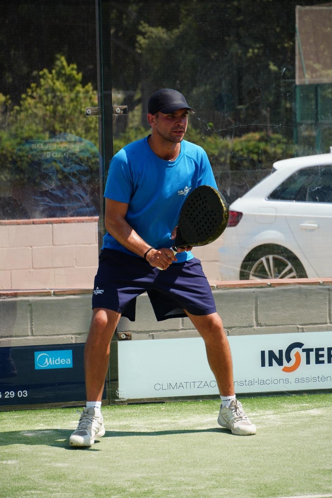 Max Martí García crouching to hit off the back wall